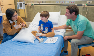 BRI clinical trial staff speaking with a child and parent